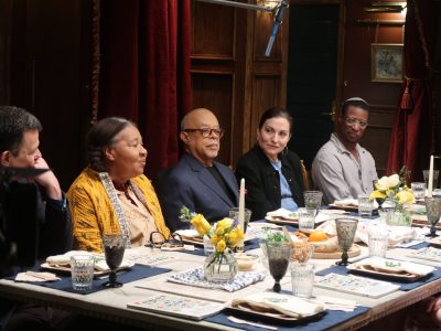 Host Henry Louis Gates Jr., center, attends a Seder while filming “Black and Jewish America: An Interwoven History.” (Image courtesy of PBS)
